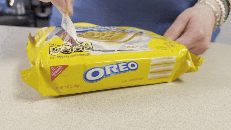 Highlighting the power of flexible packaging in action: Opening a resealable Oreo pack designed for freshness, sustainability, and consumer convenience.