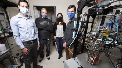 NREL scientists Eric Karp (left), Davinia Salvachua, Jeffery Linger, and Patrick Saboe have developed an energy-efficient and cost-effective process to produce butyric acid from biomass, which can be used as a precursor for renewable diesel and jet fuel. Courtesy: Dennis Schroeder, NREL