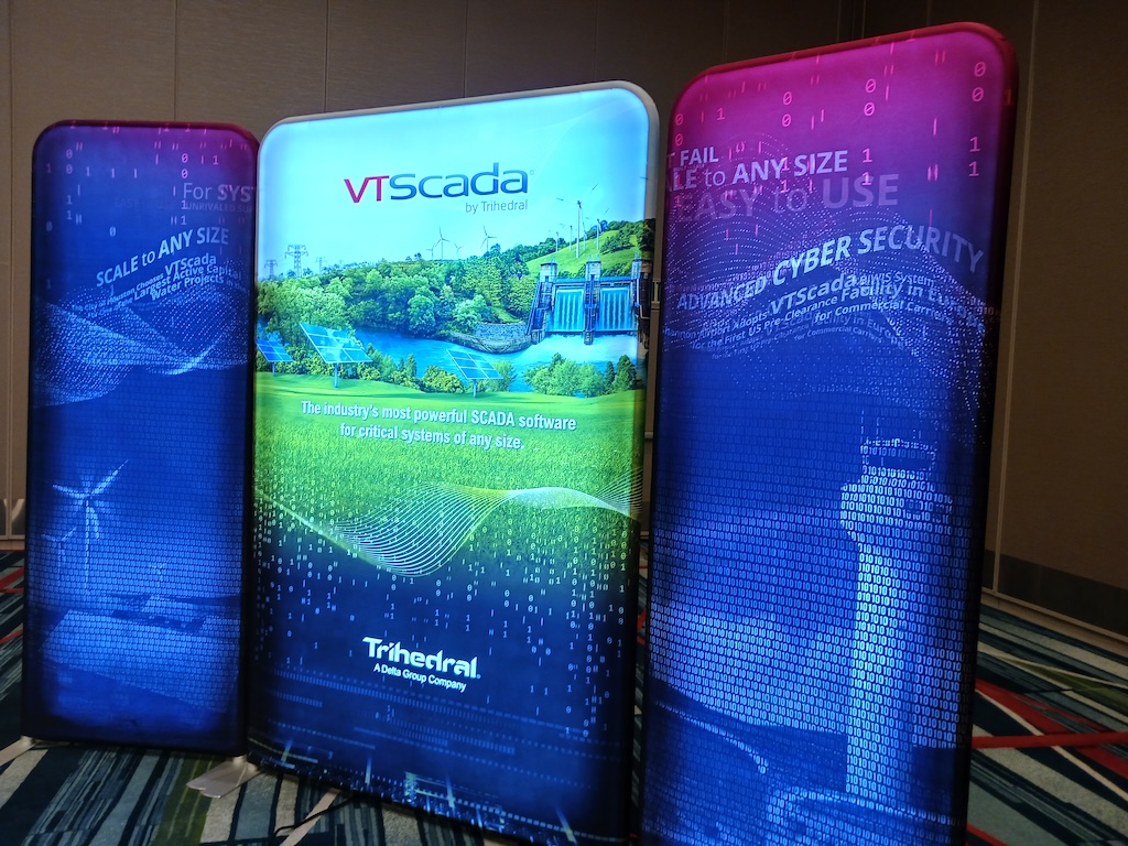 Figure 2: Backdrop for the interview with Trihedral executives at ScadaFest show some key features of the company’s supervisory control and data acquisition (SCADA) software, VTScada, including scalability for systems of any size, advanced cybersecurity and acceptance for use in critical industries. 