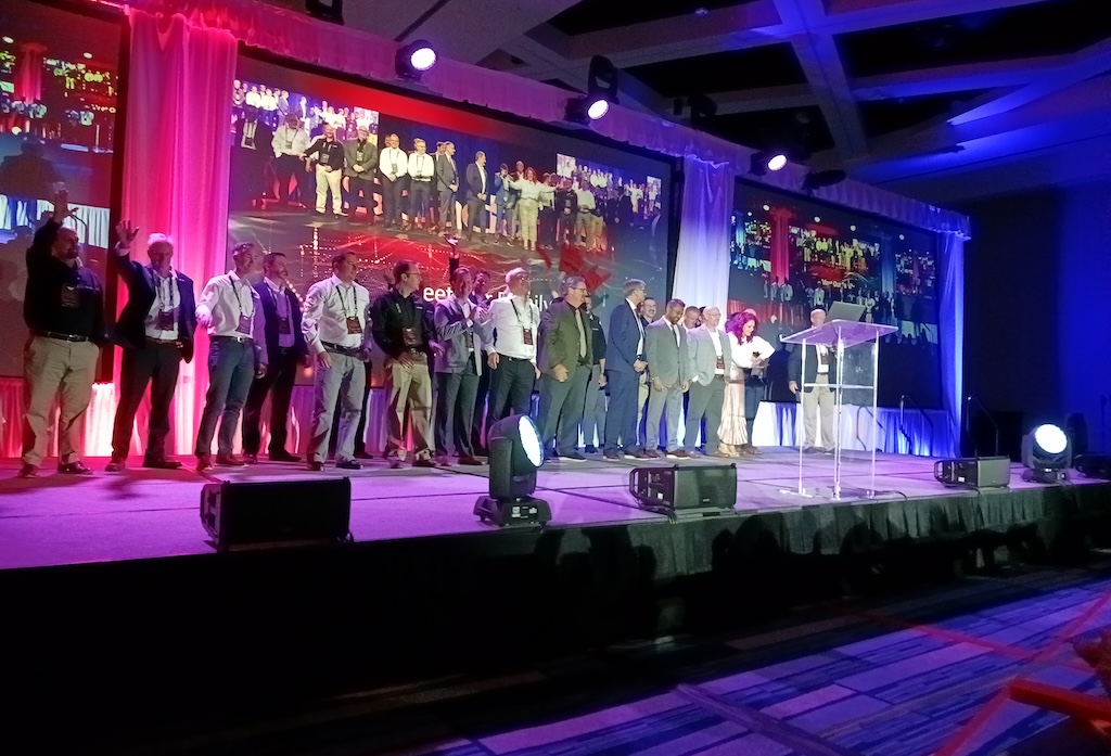 Figure 9: About 30 from the Tridhedral team gathered on stage during the 2024 ScadaFest keynote presentation, in March in Orlando. 