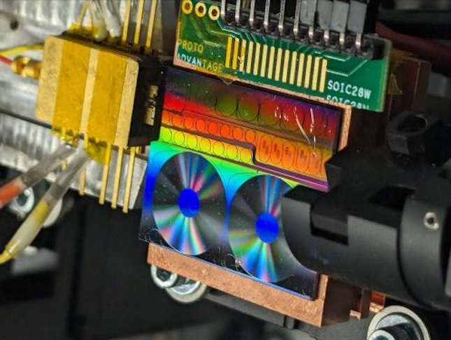 he rainbow-colored chip from collaborators at CalTech and UC - Santa Barbara contains several integrated resonators used to generate narrow line-width lasers and frequency combs used in the photonic microwave oscillator. Courtesy: University of Colorado Boulder