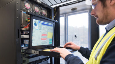 Figure 1: A control systems engineer works on a human machine interface/supervisory control and data acquisition system server. Courtesy of CDM Smith.