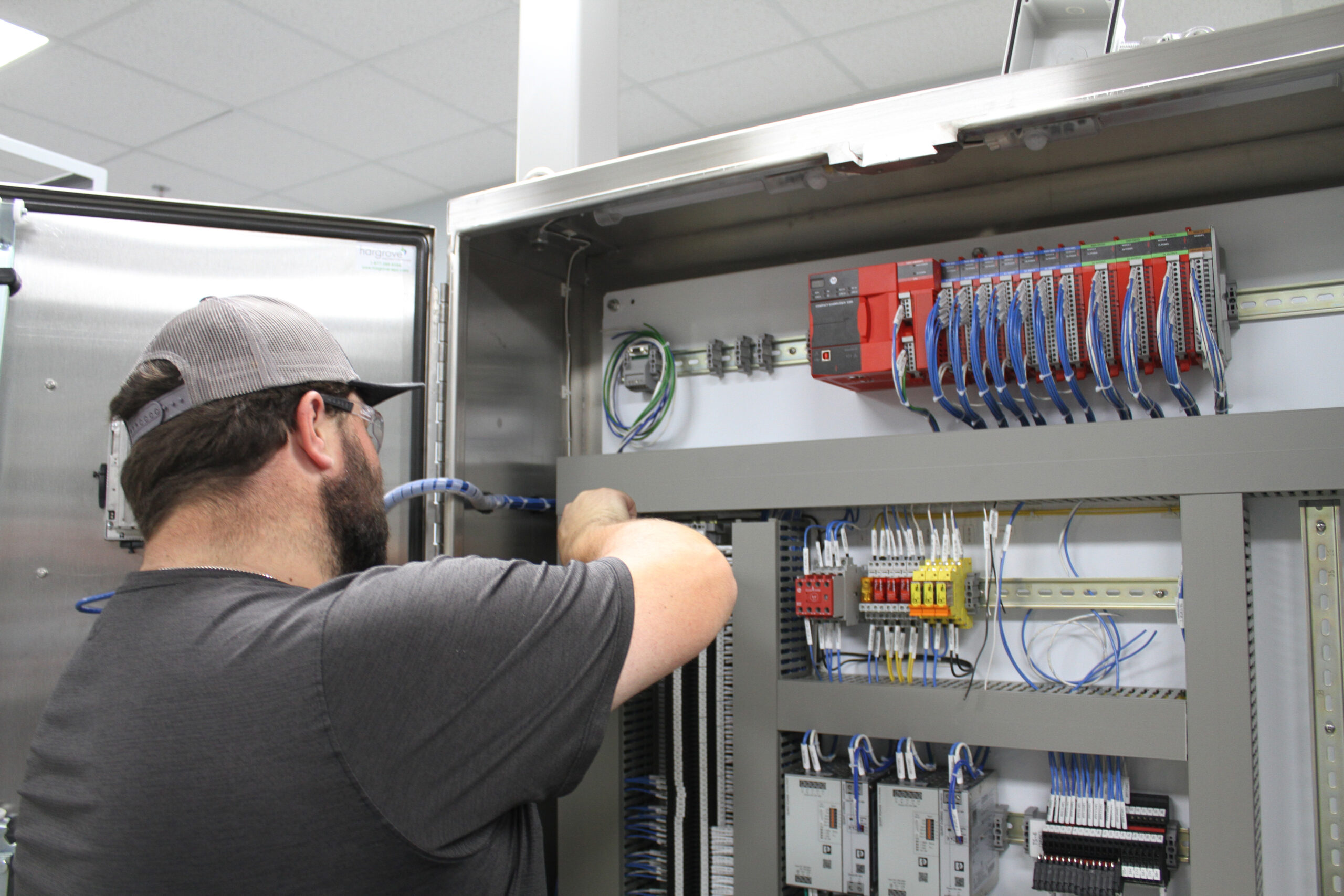Panel shop technician inspects wiring terminations for a petrochemical client. Courtesy: Hargrove Controls & Automation